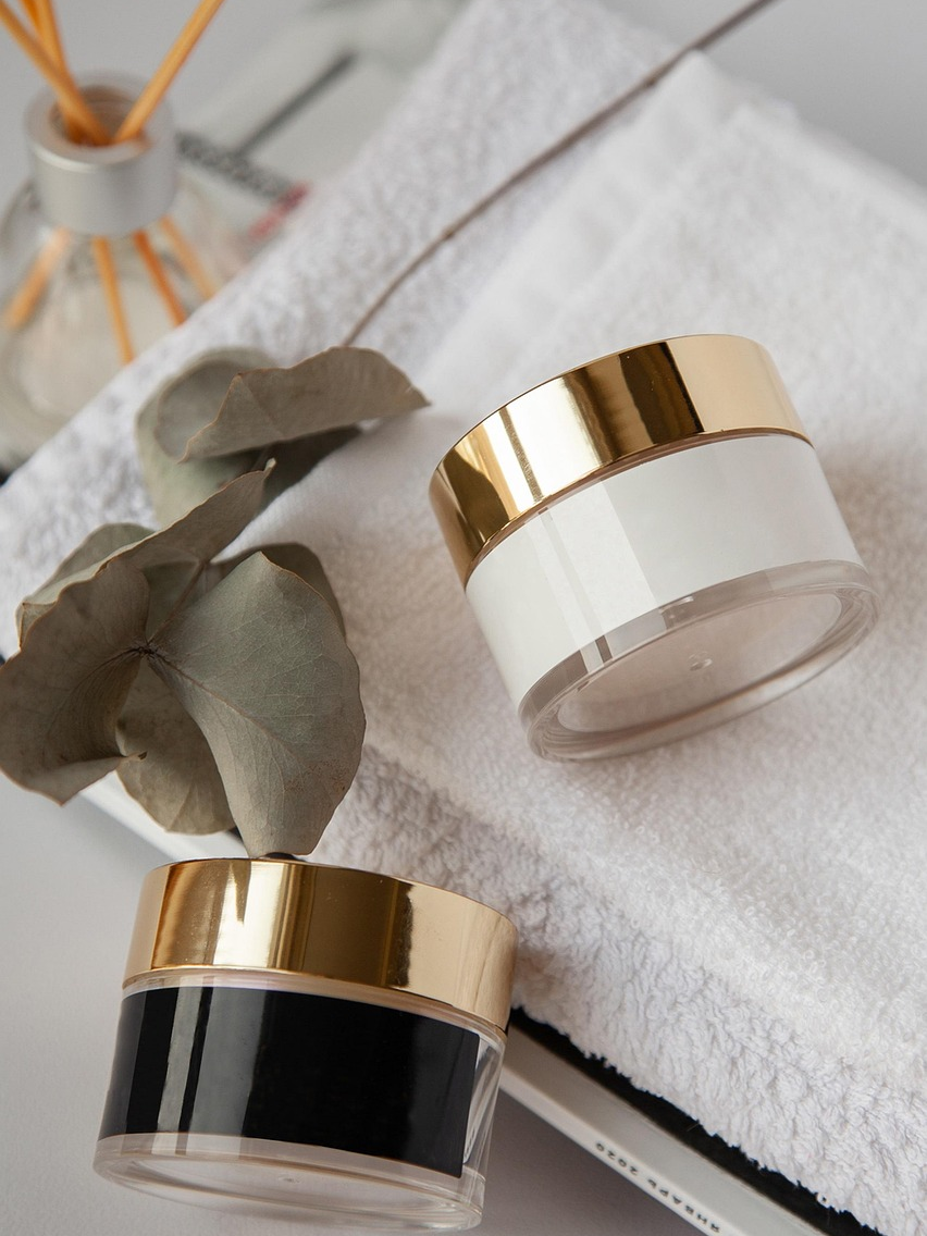 Skincare products resting on a soft folded towel