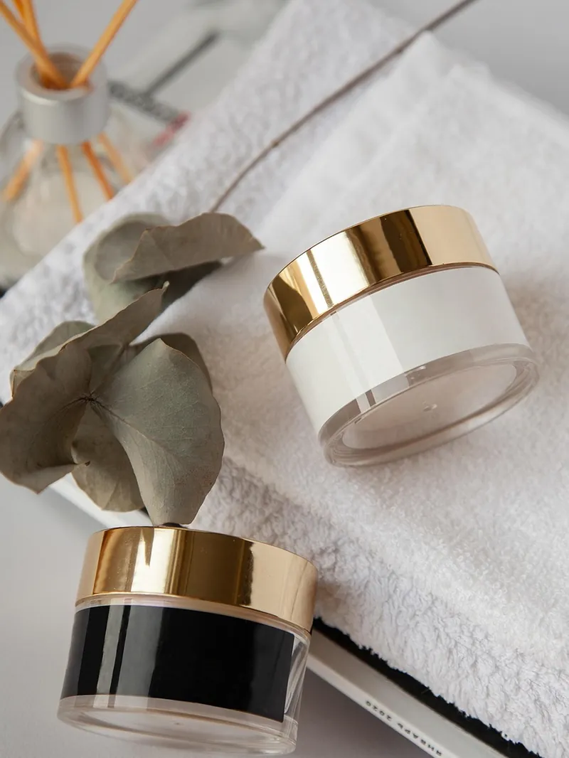 Skincare products resting on a soft folded towel